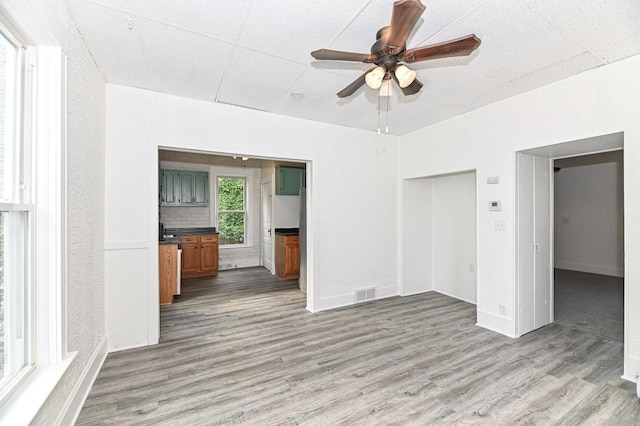 1443 Summit Ave, Racine, WI 53404 - unfurnished living room with wood finished floors and a ceiling fan