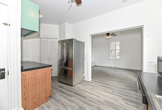 1443 Summit Ave, Racine, WI 53404 - kitchen featuring freestanding refrigerator, ceiling fan, light wood-type flooring, and dark countertops