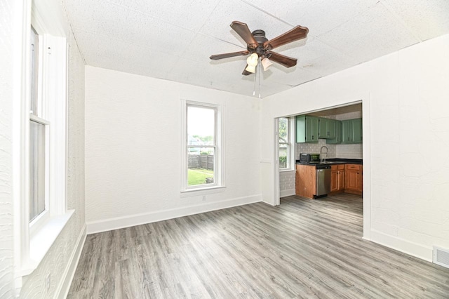 1443 Summit Ave, Racine, WI 53404 - unfurnished living room featuring light wood-type flooring and a ceiling fan