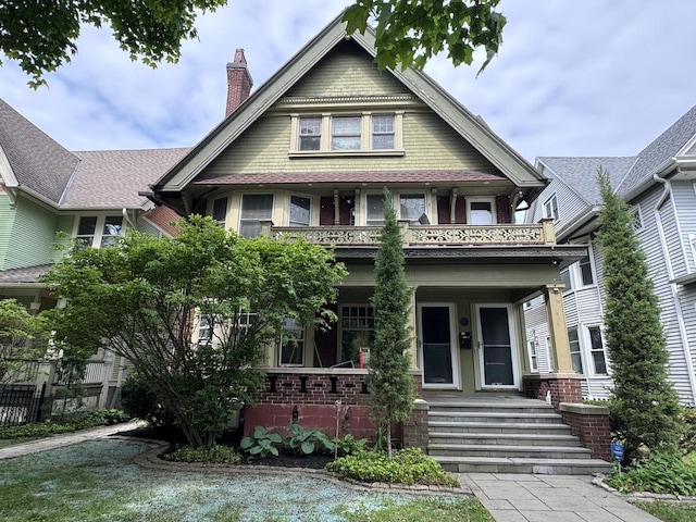 2723 N Downer Ave Unit 2725, 2725A, Milwaukee, WI 53211 - victorian-style house with covered porch, a balcony, a chimney, and brick siding