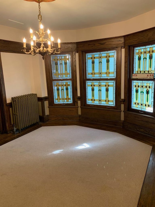 2723 N Downer Ave Unit 2725, 2725A, Milwaukee, WI 53211 - empty room with radiator, wood finished floors, and a chandelier
