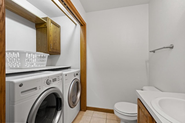106 Lamine Ln, Combined Locks, WI 54113 - washroom with washing machine and dryer, light tile patterned floors, and baseboards
