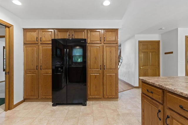 106 Lamine Ln, Combined Locks, WI 54113 - kitchen featuring black fridge, brown cabinetry, recessed lighting, baseboards, and light countertops