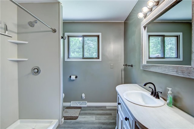 N211 County Road J, Hatfield, WI 54754 - bathroom with wood finished floors, vanity, a shower, toilet, and crown molding
