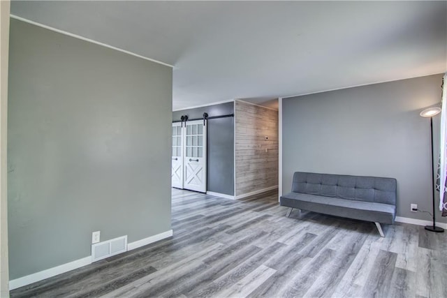 N211 County Road J, Hatfield, WI 54754 - unfurnished room with a barn door, wood finished floors, and baseboards