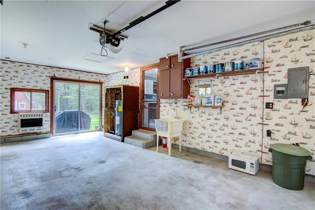 N211 County Road J, Hatfield, WI 54754 - garage with wallpapered walls, electric panel, heating unit, a garage door opener, and a sink