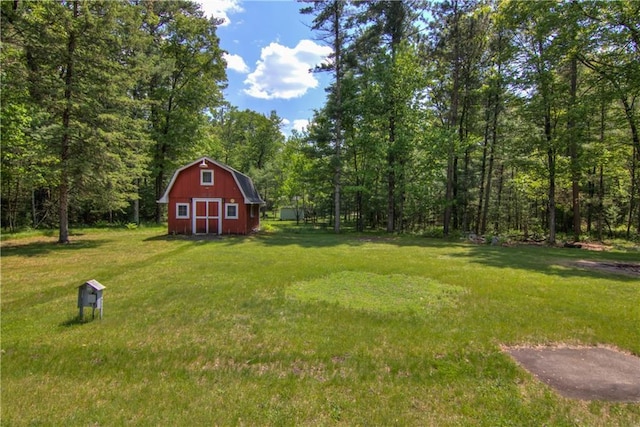 N211 County Road J, Hatfield, WI 54754 - view of green lawn featuring an outdoor structure, a barn, and a view of trees