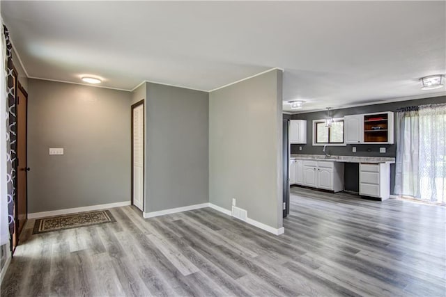N211 County Road J, Hatfield, WI 54754 - unfurnished living room featuring a sink, wood finished floors, and baseboards