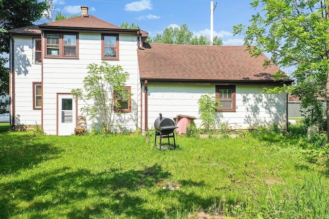 106 S Richmond Ave, Gillett, WI 54124 - rear view of house featuring a shingled roof and a lawn