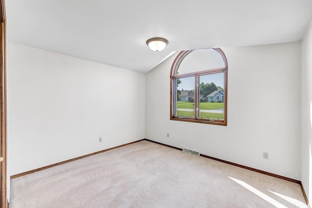 5073 Scottie Ct, New Franken, WI 54229 - empty room with lofted ceiling, light carpet, and baseboards