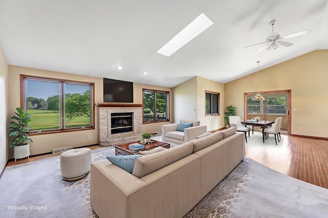5073 Scottie Ct, New Franken, WI 54229 - living area featuring vaulted ceiling, light wood-type flooring, a glass covered fireplace, baseboards, and ceiling fan
