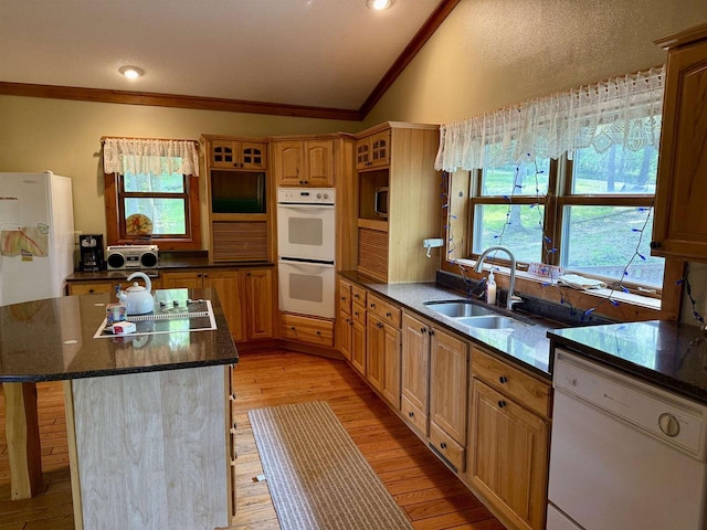 20675 Deer Island View Rd, Eastman, WI 54626 - kitchen with white appliances, a sink, lofted ceiling, crown molding, and a center island