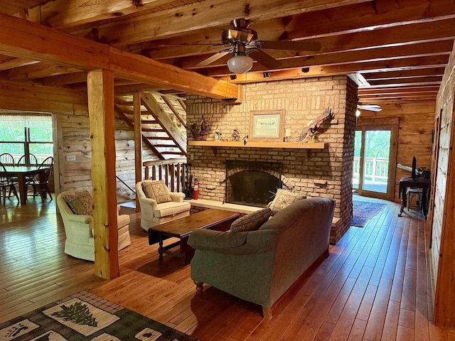 20675 Deer Island View Rd, Eastman, WI 54626 - living area featuring dark wood finished floors, plenty of natural light, ceiling fan, beam ceiling, and wooden walls