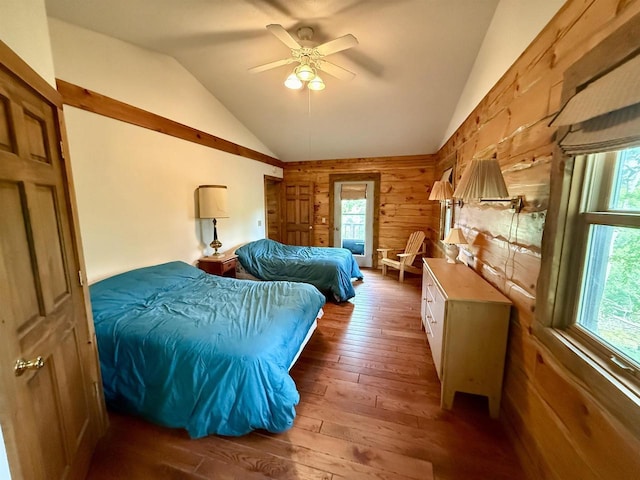 20675 Deer Island View Rd, Eastman, WI 54626 - bedroom featuring wooden walls, multiple windows, lofted ceiling, hardwood / wood-style flooring, and a ceiling fan