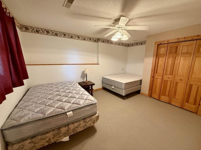 20675 Deer Island View Rd, Eastman, WI 54626 - bedroom with light colored carpet, a ceiling fan, and a textured ceiling