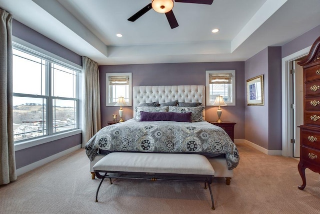 6663 S Chickahauk Trl, Middleton, WI 53562 - bedroom with light carpet, multiple windows, baseboards, and a tray ceiling