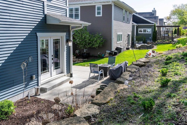6663 S Chickahauk Trl, Middleton, WI 53562 - view of property exterior with a patio, a fire pit, and french doors