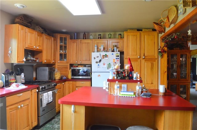 4878N Fur Farm Trl, Winter, WI 54896 - kitchen with appliances with stainless steel finishes, a kitchen island, a kitchen breakfast bar, glass insert cabinets, and light countertops