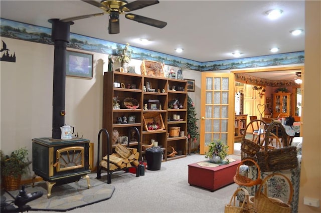 4878N Fur Farm Trl, Winter, WI 54896 - living area featuring a wood stove, ceiling fan, carpet flooring, and recessed lighting