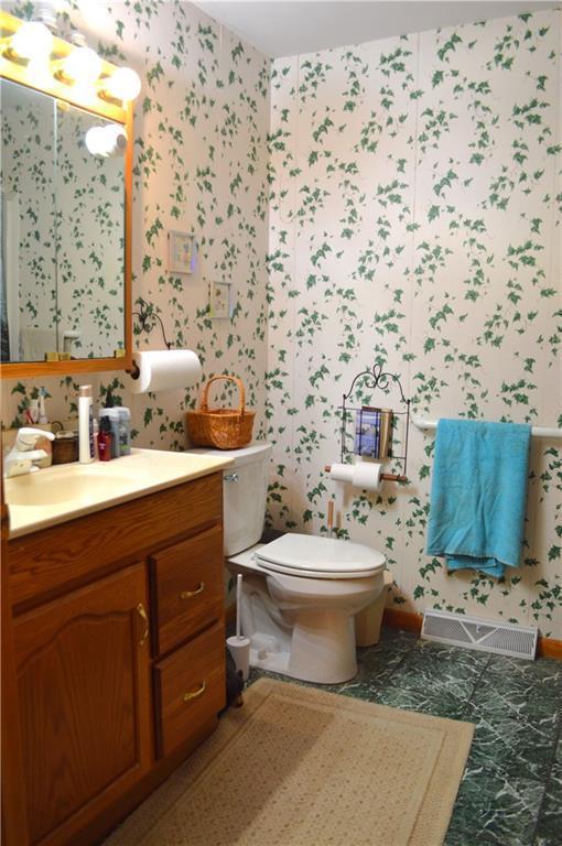 4878N Fur Farm Trl, Winter, WI 54896 - bathroom featuring wallpapered walls, vanity, and toilet