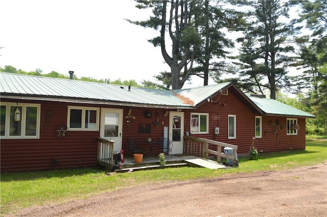 4878N Fur Farm Trl, Winter, WI 54896 - view of front of house featuring metal roof, faux log siding, and a front yard