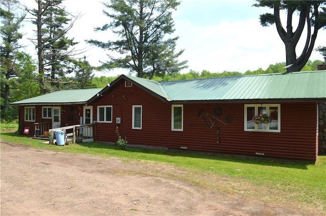 4878N Fur Farm Trl, Winter, WI 54896 - view of side of property with metal roof, a lawn, and crawl space