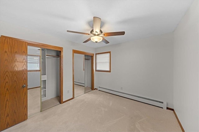 1365 Woodbridge St, Saint Paul, MN 55117 - unfurnished bedroom featuring baseboard heating, carpet flooring, two closets, and a baseboard radiator