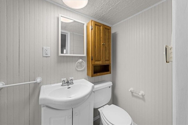 1365 Woodbridge St, Saint Paul, MN 55117 - bathroom with toilet, vanity, an ornate ceiling, and wood walls