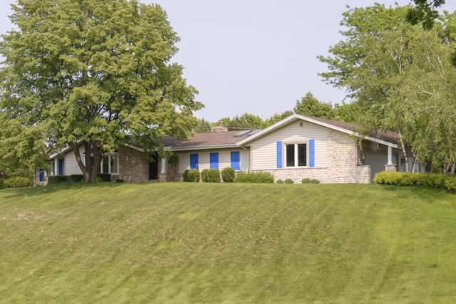 W338S4370 Drumlin Dr, Dousman, WI 53118 - view of front of property with stone siding and a front yard