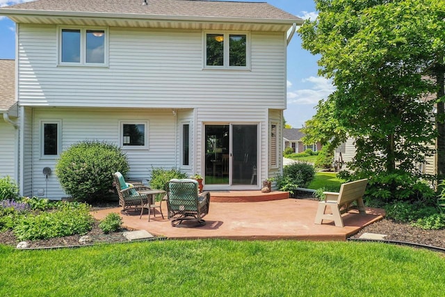 2592 Radinz Rd, Green Bay, WI 54311 - rear view of property with a lawn, a patio, and a shingled roof