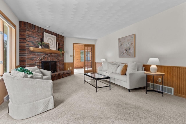 146 Old Orchard Ln, Neenah, WI 54956 - carpeted living room featuring wooden walls, a wainscoted wall, and a fireplace