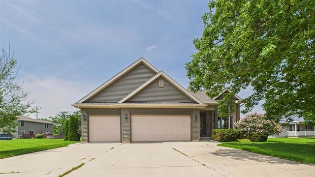 N6464 Canterbury Dr, Fond Du Lac, WI 54937 - view of front facade with a front lawn and an attached garage