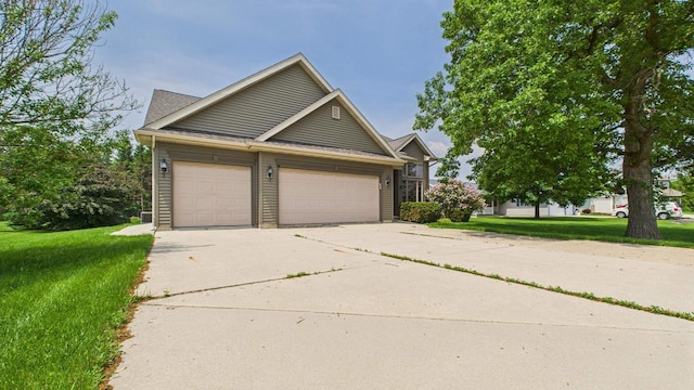 N6464 Canterbury Dr, Fond Du Lac, WI 54937 - view of front of property with a front lawn, an attached garage, and driveway