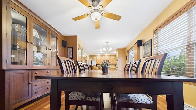 N6464 Canterbury Dr, Fond Du Lac, WI 54937 - dining area with wood finished floors, a chandelier, and ceiling fan