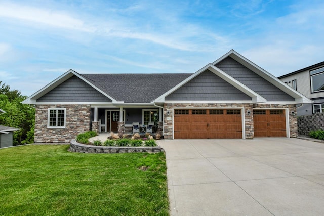 392 Campbell Hill Ct, Deforest, WI 53532 - craftsman-style home with stone siding, a garage, driveway, a front lawn, and a porch