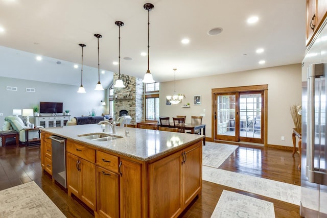392 Campbell Hill Ct, Deforest, WI 53532 - kitchen featuring a sink, open floor plan, dark wood-style floors, stainless steel appliances, and light stone countertops