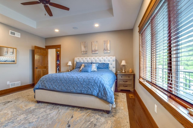 392 Campbell Hill Ct, Deforest, WI 53532 - bedroom featuring a tray ceiling, wood finished floors, recessed lighting, multiple windows, and baseboards