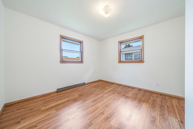 1500 E Lindbergh St, Appleton, WI 54911 - unfurnished room featuring wood finished floors, baseboards, and a baseboard heating unit
