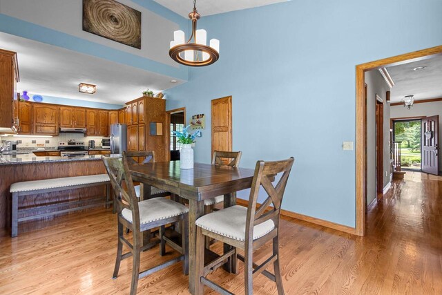 3544 Windsong Ter, Oshkosh, WI 54904 - dining space featuring light wood-style flooring, a chandelier, and baseboards