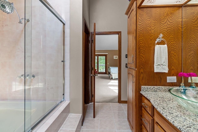 3544 Windsong Ter, Oshkosh, WI 54904 - ensuite bathroom with tiled shower / bath combo, vanity, tile patterned flooring, and baseboards