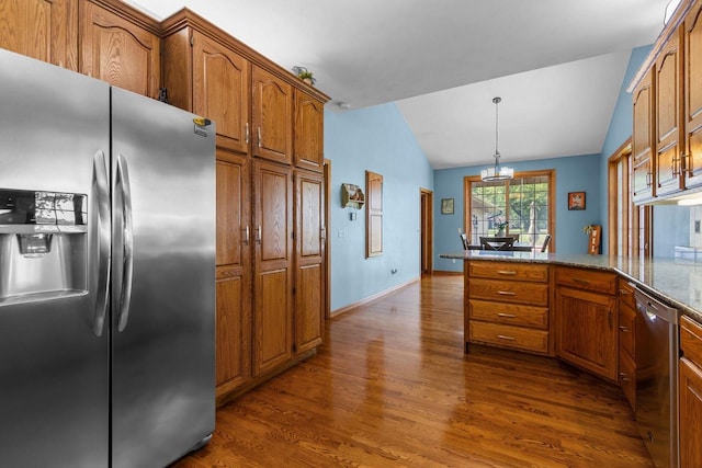 3544 Windsong Ter, Oshkosh, WI 54904 - kitchen with stainless steel appliances, lofted ceiling, dark wood-style floors, brown cabinetry, and a peninsula