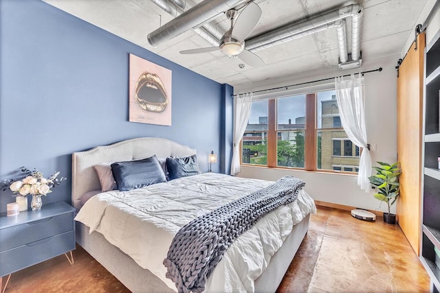 102 N Water St Unit 411, Milwaukee, WI 53202 - bedroom featuring concrete flooring, a barn door, and ceiling fan