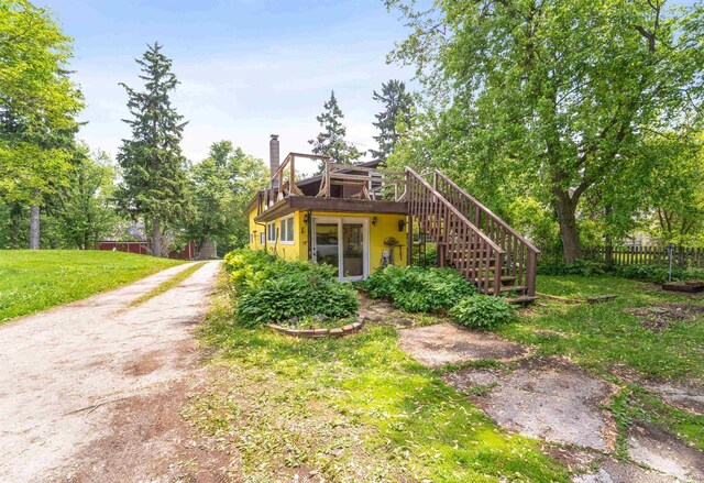 N7618 County Road C, Eldorado, WI 54932 - view of front of home featuring stairs, a chimney, and a wooden deck