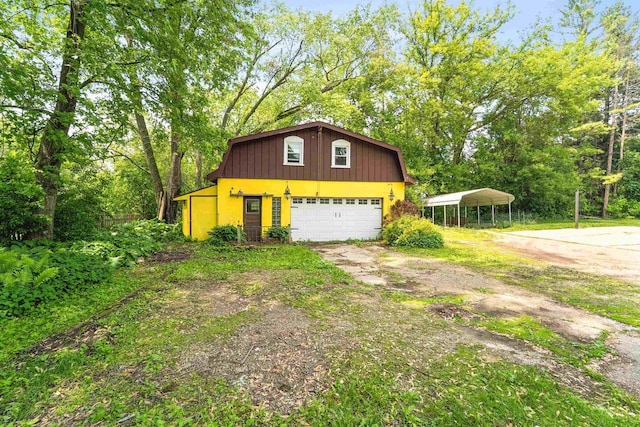 N7618 County Road C, Eldorado, WI 54932 - view of side of home featuring driveway, a gambrel roof, a detached carport, and a garage