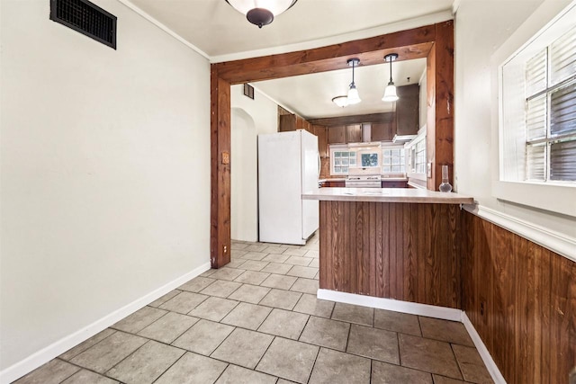 N7618 County Road C, Eldorado, WI 54932 - kitchen with white appliances, a peninsula, light countertops, arched walkways, and baseboards