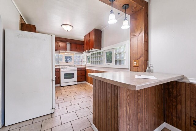 N7618 County Road C, Eldorado, WI 54932 - kitchen featuring white appliances, a peninsula, light countertops, light tile patterned flooring, and brown cabinets
