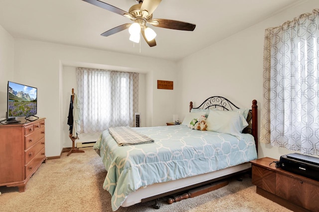 2020 Meadow Ct Unit 2, West Bend, WI 53095 - bedroom featuring baseboard heating, light carpet, ceiling fan, and baseboards