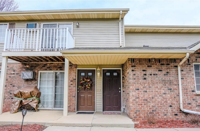 2020 Meadow Ct Unit 2, West Bend, WI 53095 - entrance to property with a balcony and brick siding