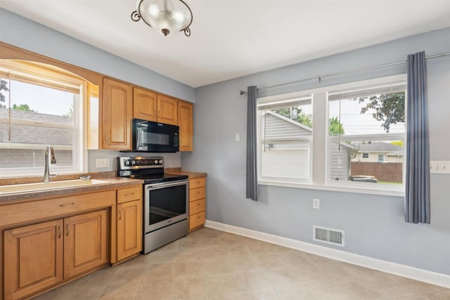 476 Taft St, Fond Du Lac, WI 54935 - kitchen with black microwave, stainless steel electric range oven, a sink, baseboards, and light tile patterned flooring