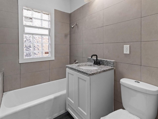 2544 N 35th St Unit 2546, Milwaukee, WI 53210 - full bathroom with tile walls, toilet, vanity, and washtub / shower combination